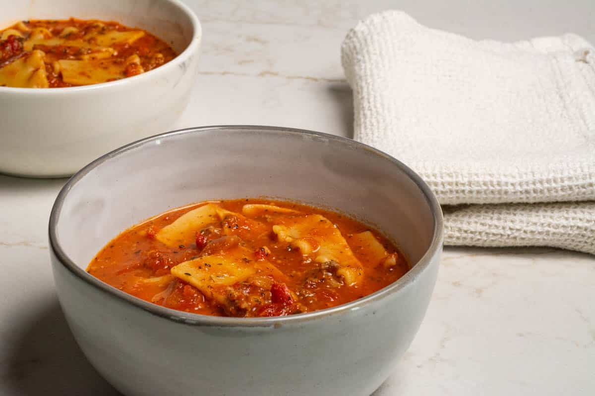 Two round bowls of one-pot lasagna soup.