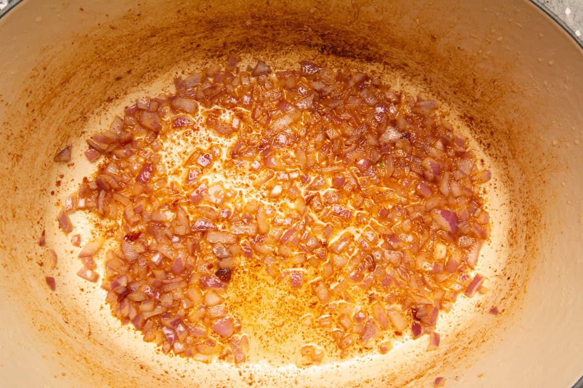 A Dutch Oven with sautéed onions.