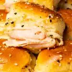 A few turkey slider on Hawaiian rolls stacked on top of each other.