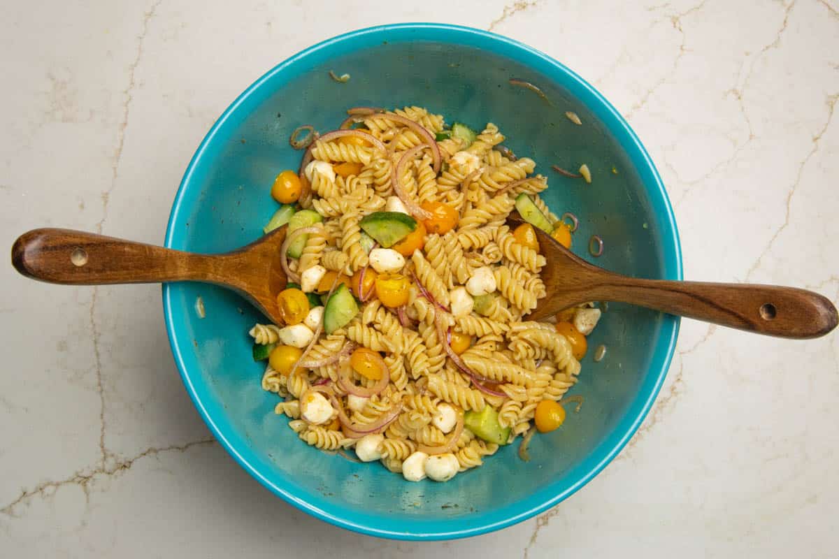 Mozzarella pasta salad in a grey bowl.