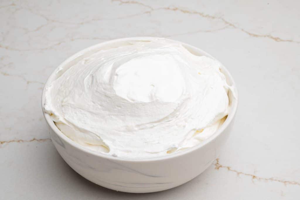 A small bowl filled with Cool Whip fruit dip.