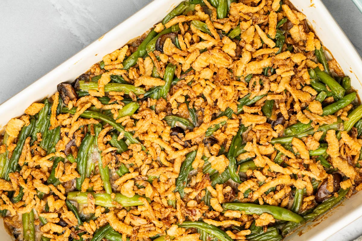 An overhead view of fresh green bean casserole in a baking dish.