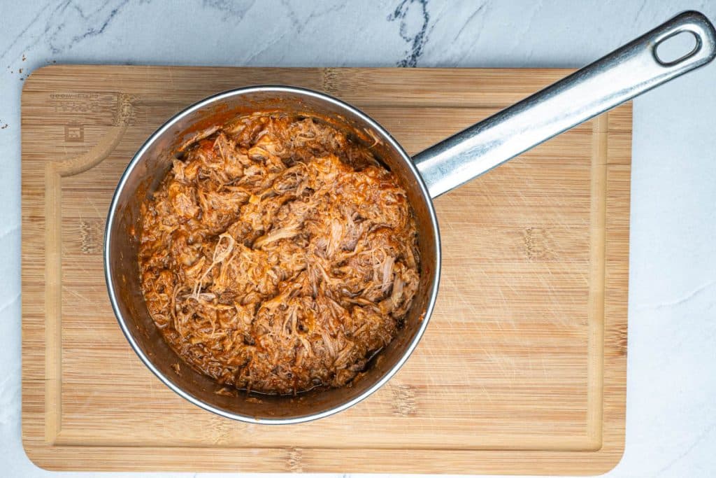 Pulled pork and barbecue sauce in a medium saucepan.